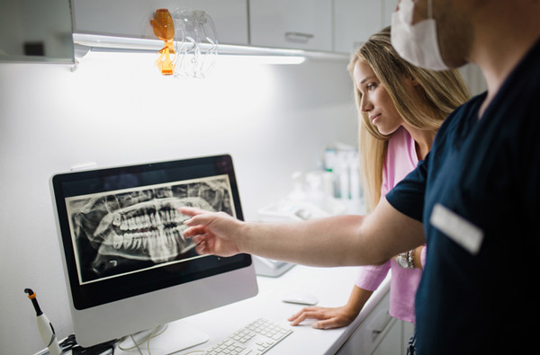 Dentist reviewing a digital xray Dentist reviewing a digital xray